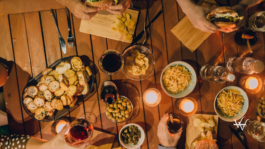 Friends Eating and Drinking Wine Outdoors at Night