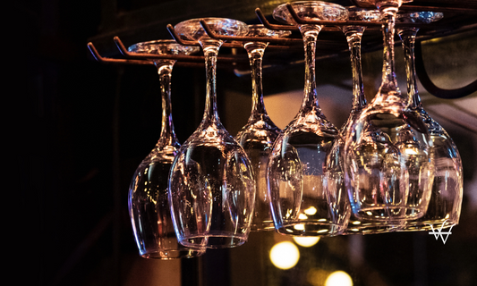 Glasses hanging over bar rack, Glasses suspended above a bar