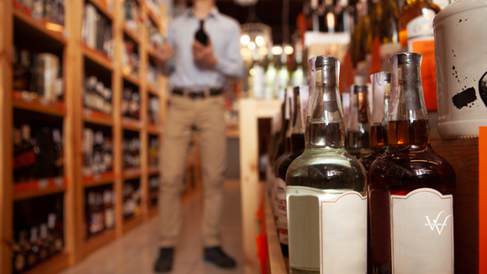 Handsome man shopping for alcohol at liquor store