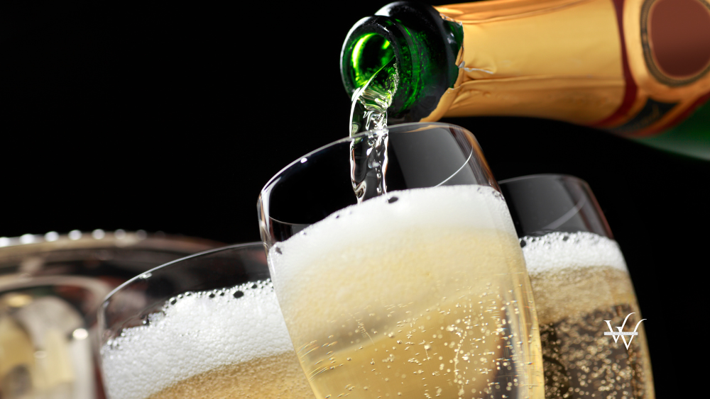 Champagne being poured into champagne glasses