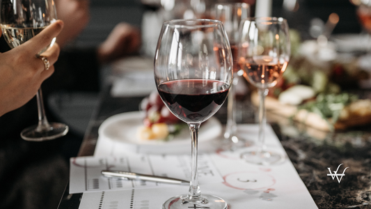 Clear Wine Glass on White Paper