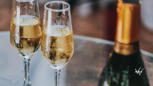 Open Champagne Bottle Near Two Cocktail Glasses