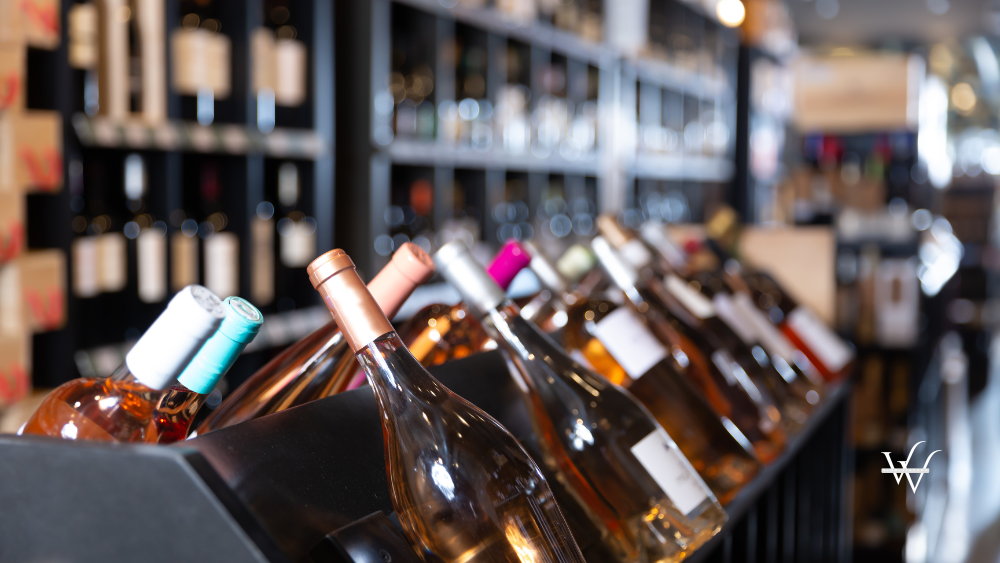 Rack with sparkling wine bottles in wine store