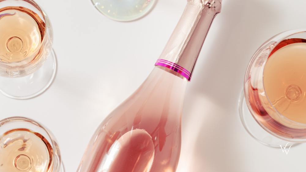 Rose wine assortment in crystal glasses, bottle of rose champagne sparkling wine. Summer alcoholic drink