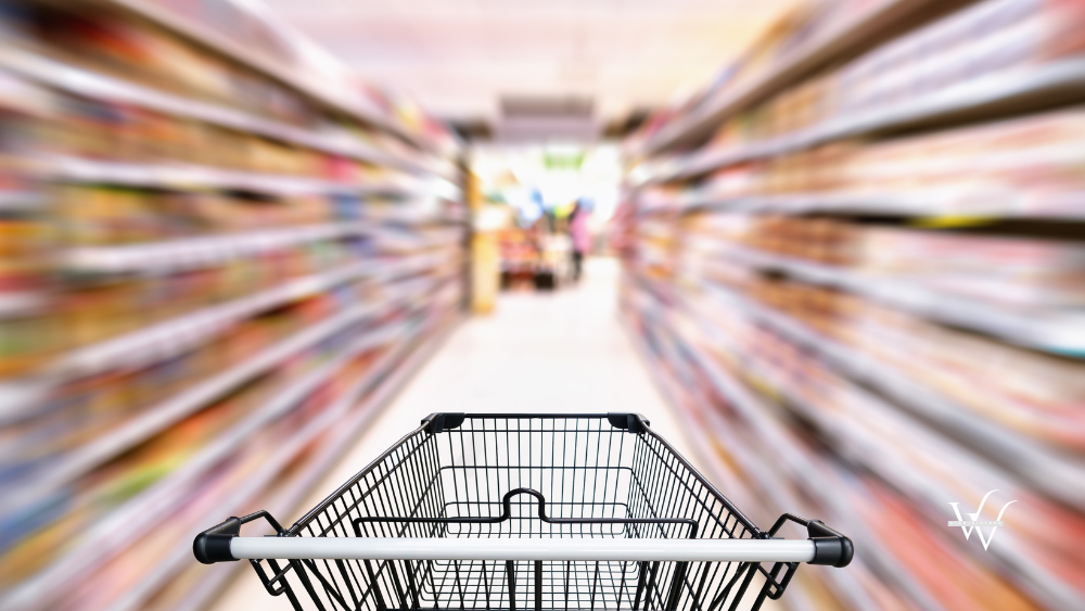 Shopping trolley in department store with consumer goods product on shelf background, Abstract motion blurred concept