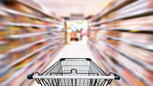 Shopping trolley in department store with consumer goods product on shelf background, Abstract motion blurred concept