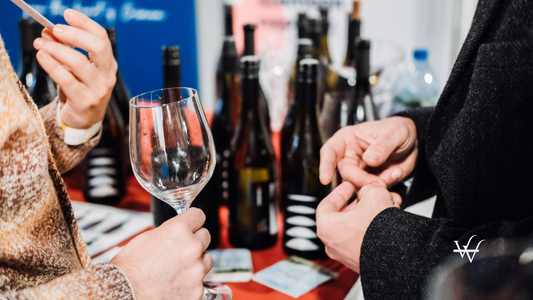Trade Visitors Networking Over Wine Tasting at Wine Fair
