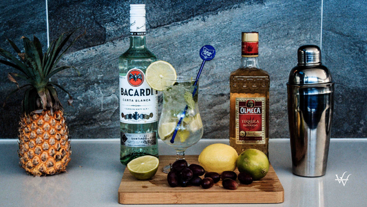 Two Liquor Bottles Near Fruits