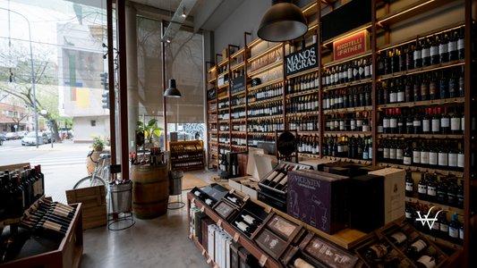 View of a wine shop with shelves and stands full of wine bottles