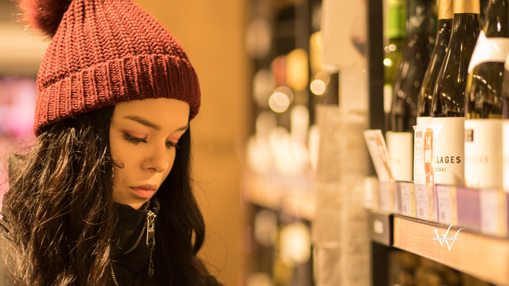 Woman_picking_wine_in_store