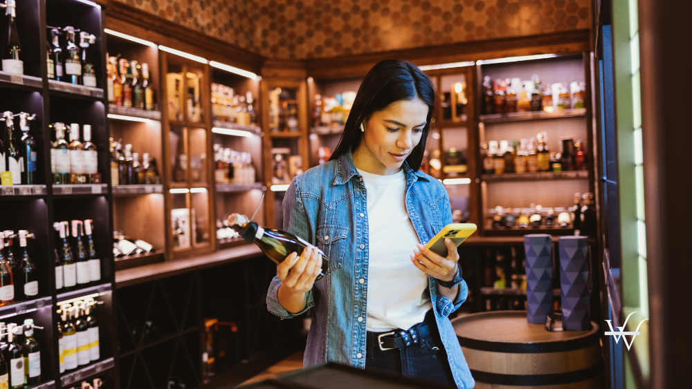 Woman_with_Phone_Choosing_Liquor_in_the_Store