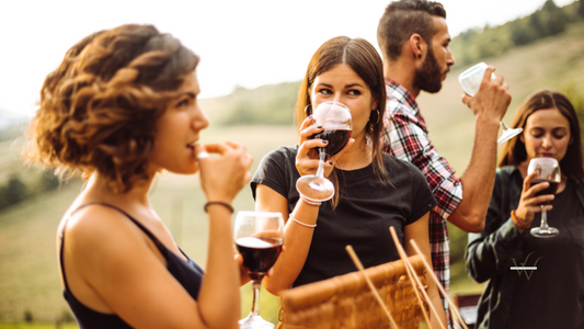people drinking red wine outdoors
